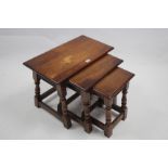 An oak nest of three rectangular occasional tables each table on four baluster-turned legs with