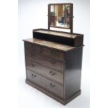 A mid 20th century oak dressing chest with rectangular swing mirror to the stage back, fitted two