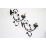 A pair of wrought-metal wall lights of scroll design, 8" long