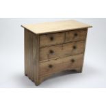 A pine dwarf chest fitted two short and two long graduated drawers with turned knob handles, and