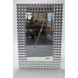 A contemporary rectangular wall mirror inset bevelled plate, and with roundels to border, 47" x