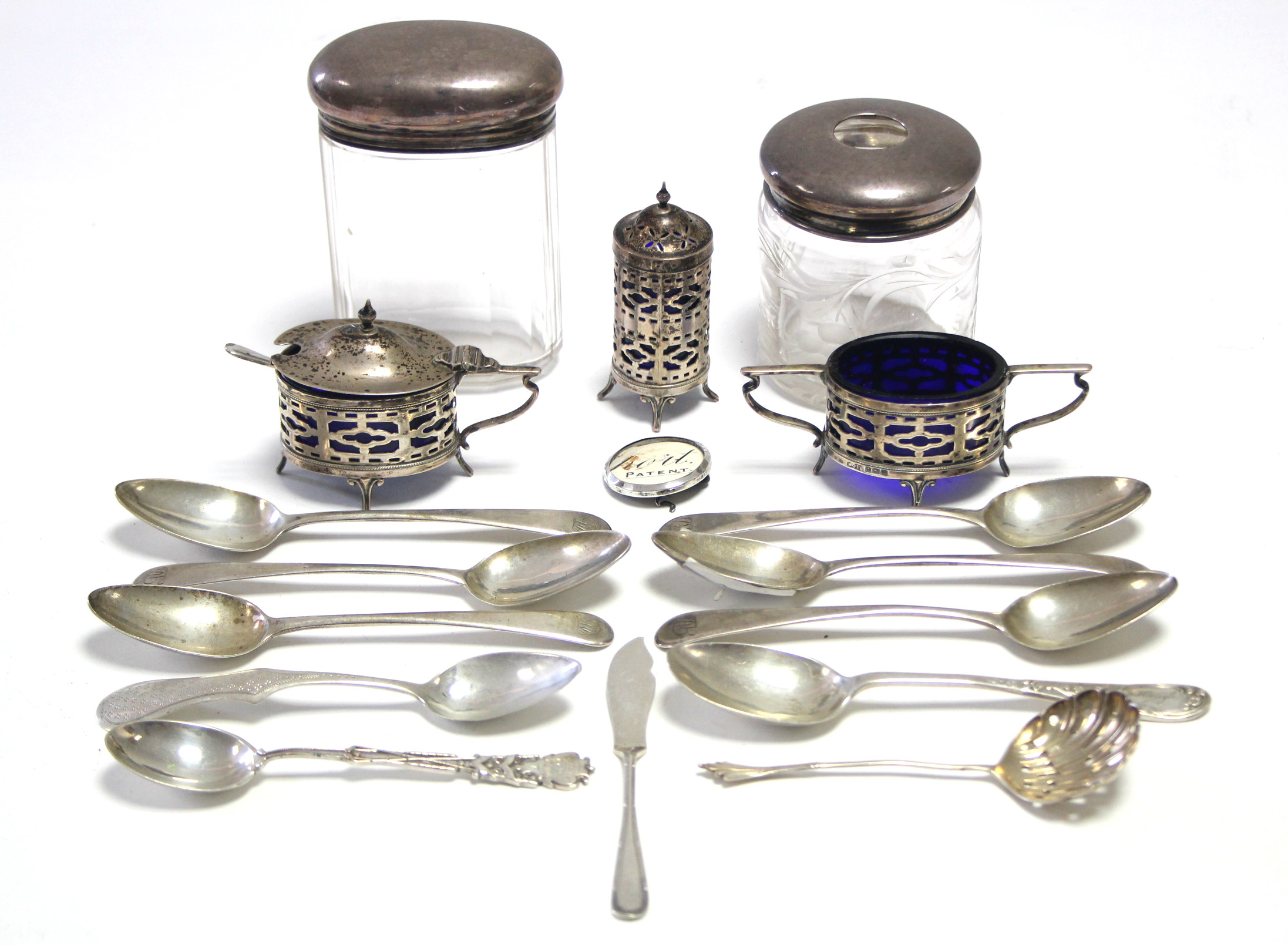 A George V silver three-piece condiment set. Birmingham 1922; two glass receptacles with silver