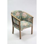 An oak frame tub-shaped chair; together with three occasional chairs; & two oval wall mirrors.