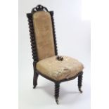 A 19th century beech nursing chair with padded back & sprung seat, & on spiral-twist legs.