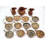 A set of twelve Mexican pottery cooking pans, each with bright-coloured geometric design; a ditto