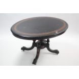 A Victorian inlaid ebonised & walnut crossbanded pedestal dining table with oval tilt-top, & on four
