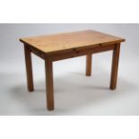A pine kitchen table with rectangular top, & on square legs, 48” x 30”.
