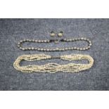 A necklace of silver-coloured metallic beads; a multi-strand necklace of small baroque pearls; & a