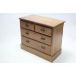 A late Victorian walnut dwarf chest fitted two short and two long graduated drawers with iron