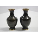 A small pair of cloisonné ovoid vases of black ground & with all-over repeating gold geometric