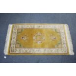 A modern Chinese rug of yellow & ivory ground & with multi-coloured floral design, 60” x 36”.