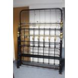 A Victorian style black-finish metal and brass 4' 6" bedstead complete with sprung base and side