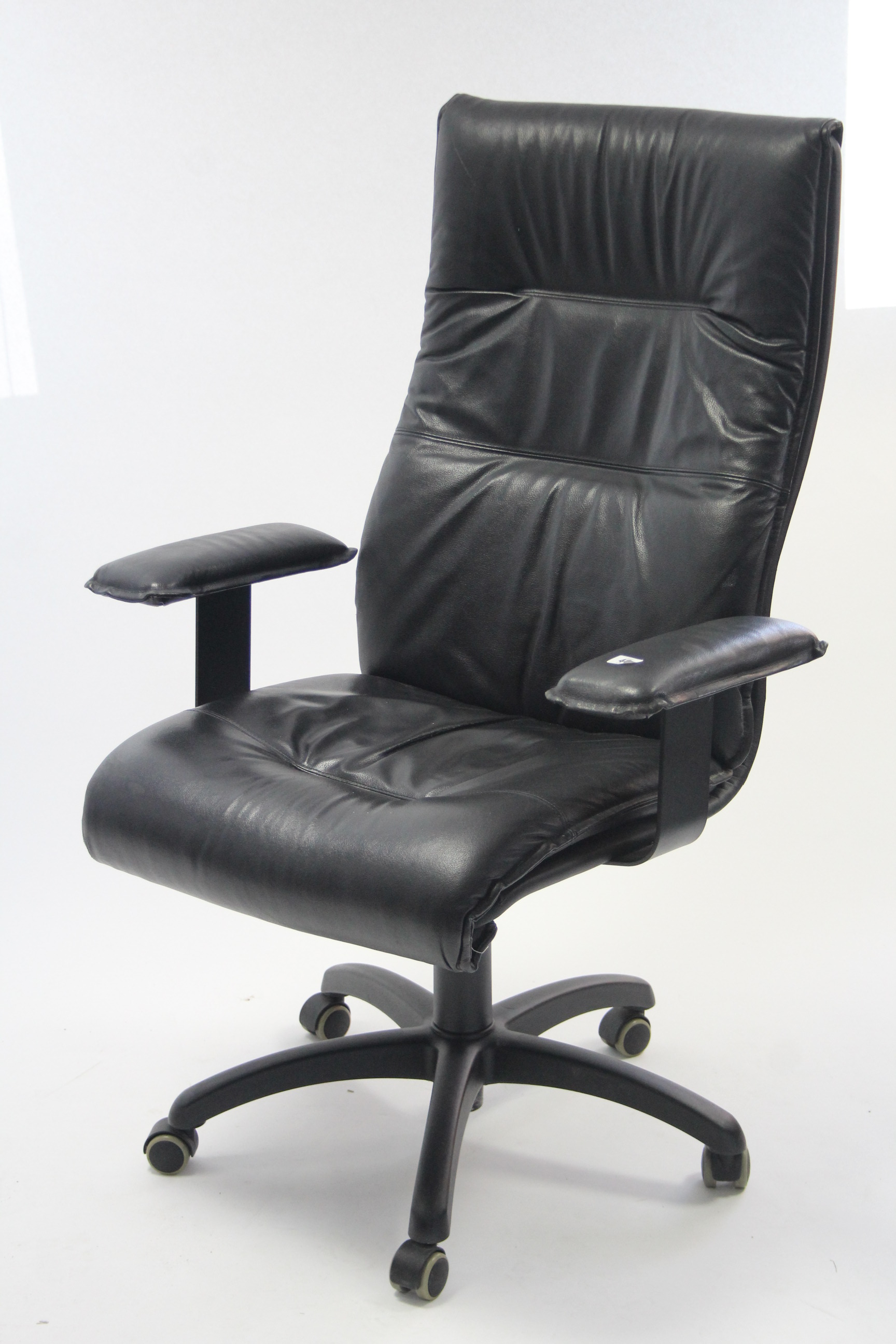 A black vinyl swivel office chair.