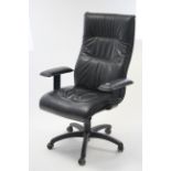 A black vinyl swivel office chair.