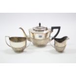 An EPNS three-piece tea service of oval semi-fluted design.