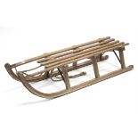 A wooden sledge, 43” long.