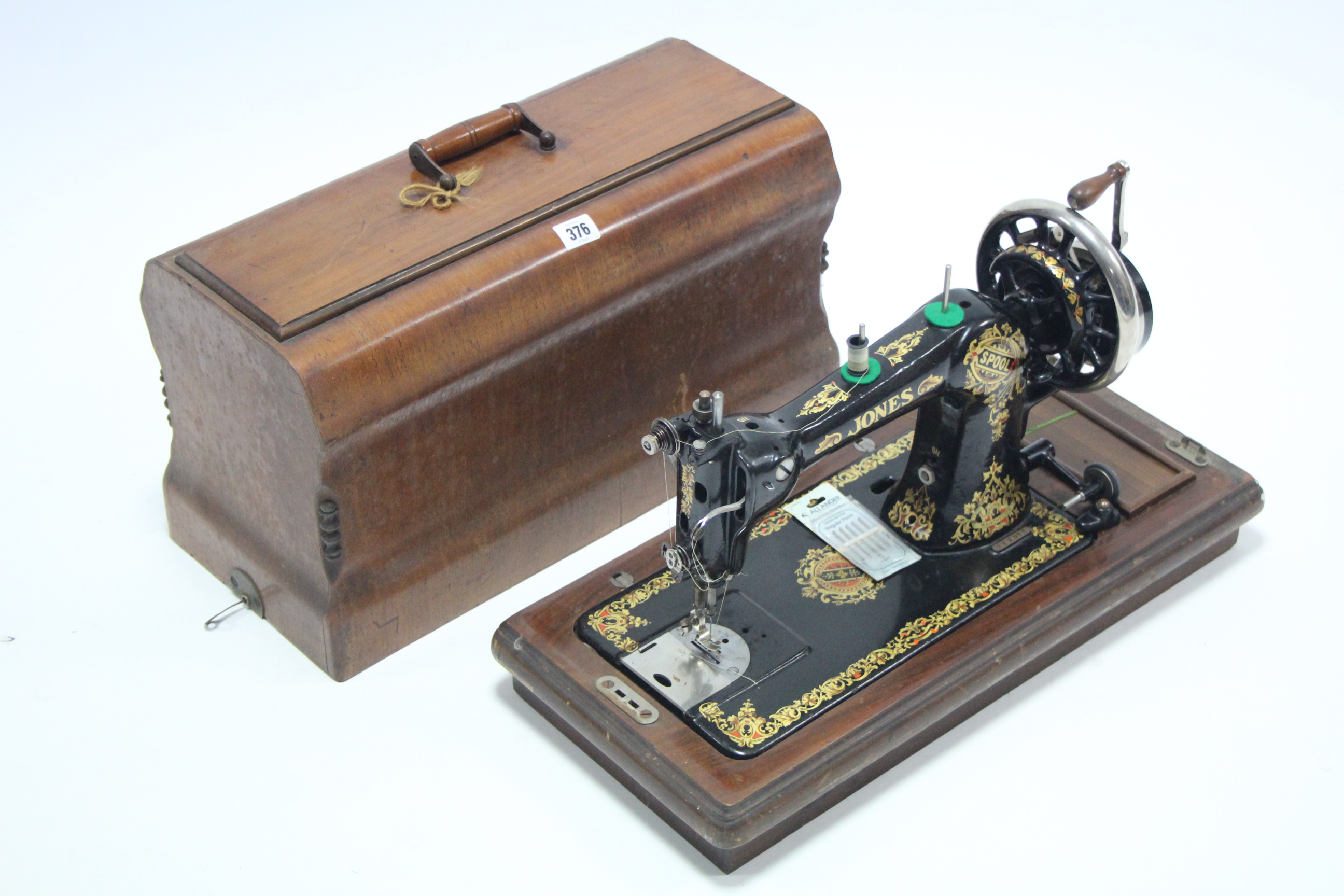 A Jones hand sewing machine with mahogany case.