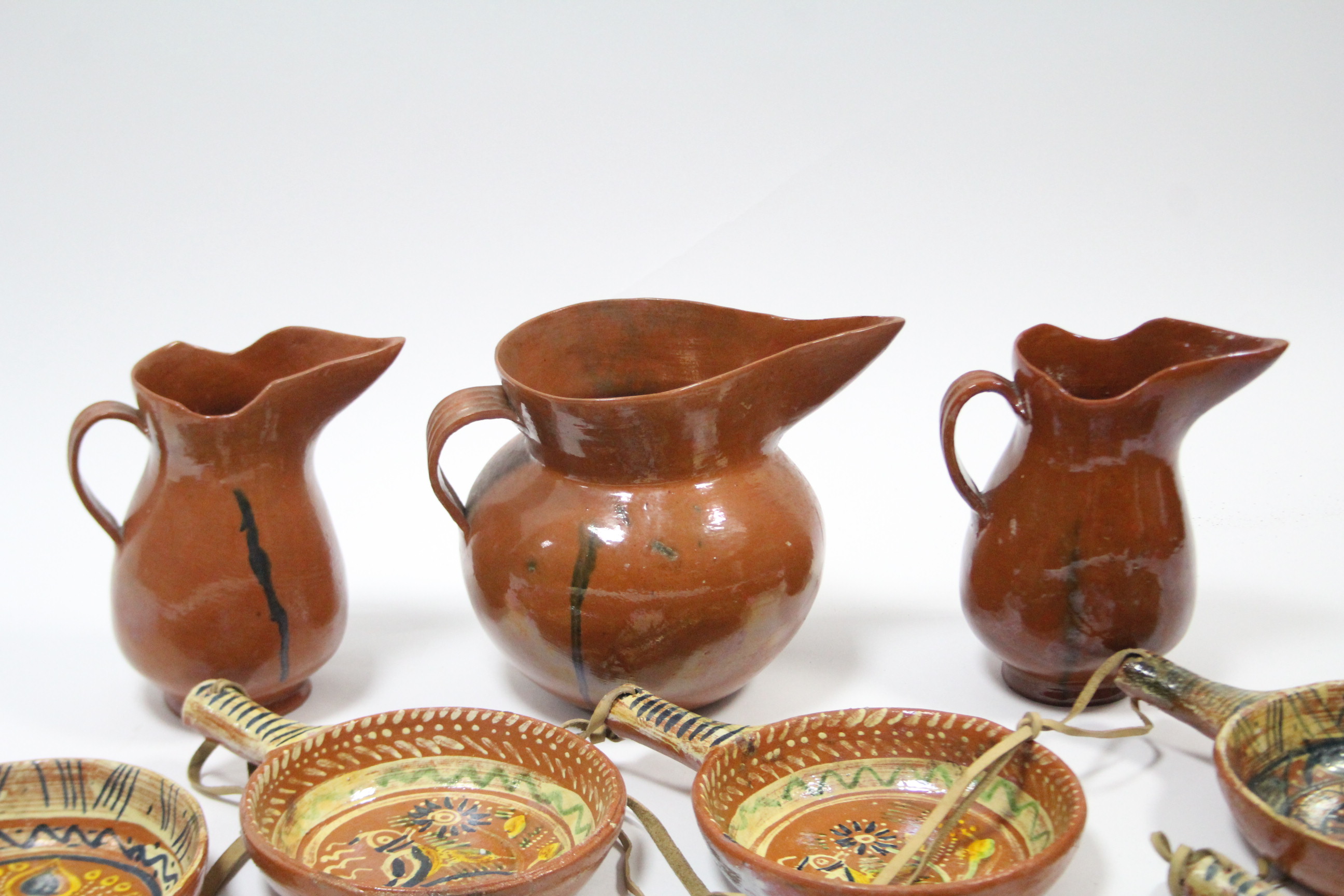 A set of twelve Mexican pottery cooking pans, each with bright-coloured geometric design; a ditto - Image 2 of 10