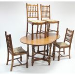 An oak oval gate-leg dining table on baluster-turned legs with turned stretchers, 35¼” x 58¾”; and a