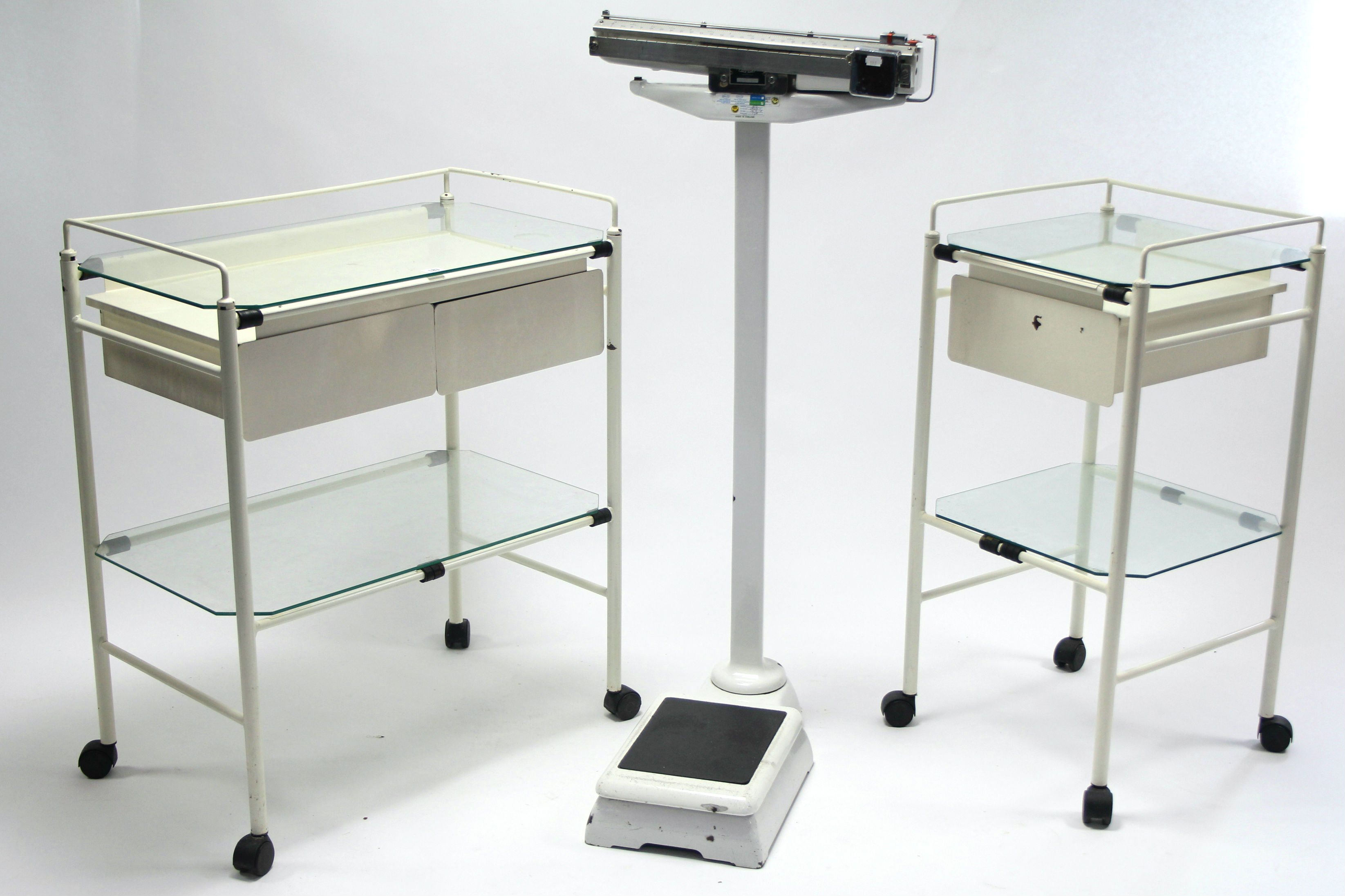 A white-metal finish rectangular two-tier medical trolley fitted two drawers to the upper tier, 29½”