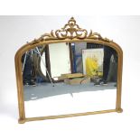 A late 19th/early 20th century giltwood frame overmantel mirror with pierced & carved scroll