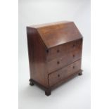 A 19th century oak bureau with fitted interior enclosed by fall-front above two short & two long