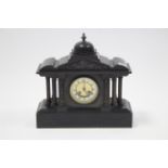 A Victorian mounted clock with black roman numerals to the white enamel dial, with striking