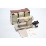 A Singer electric sewing machine with case, w.o.