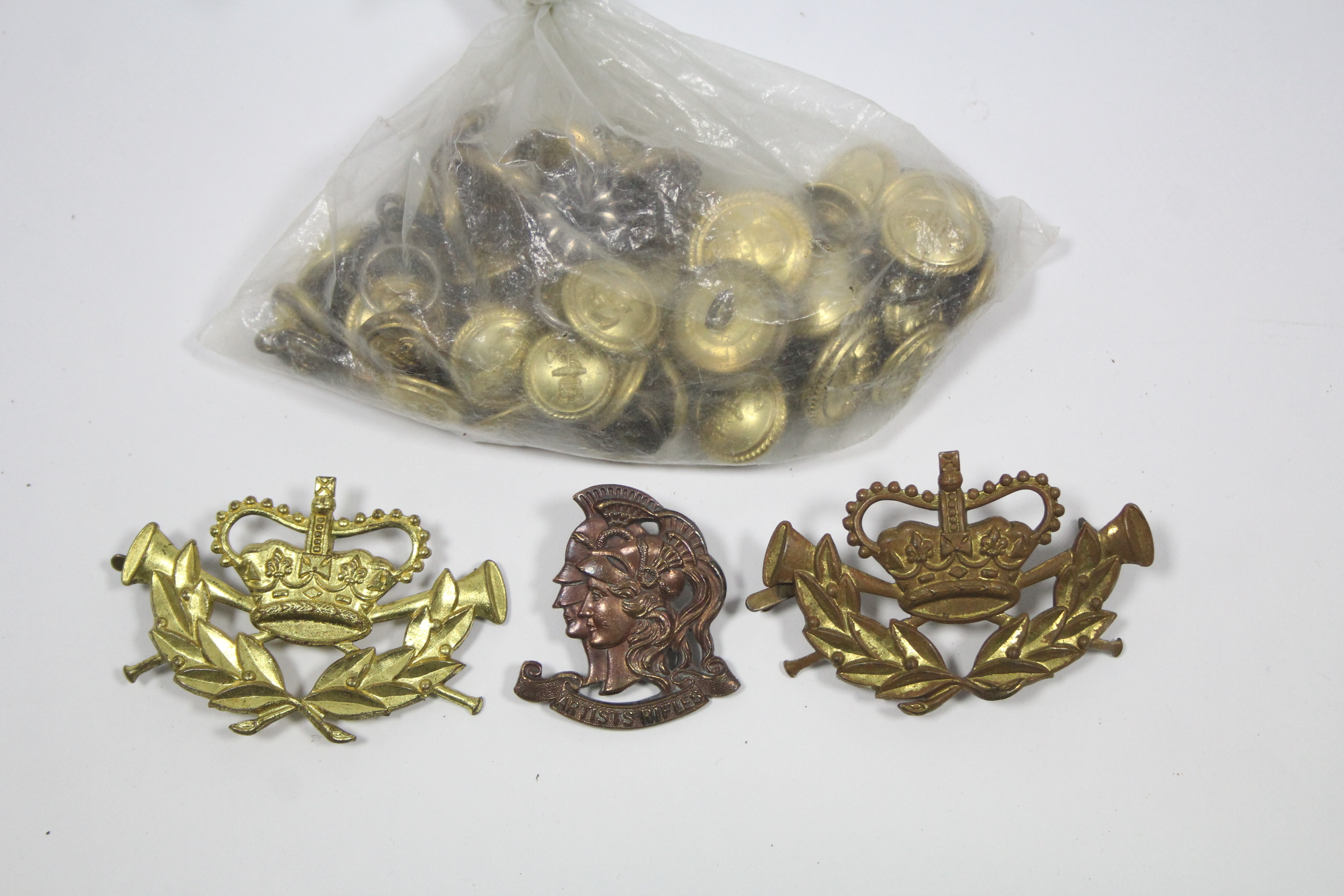 An “Artist’s Rifles” regiment cap badge; two other cap badges; & various Royal Navy tunic buttons.