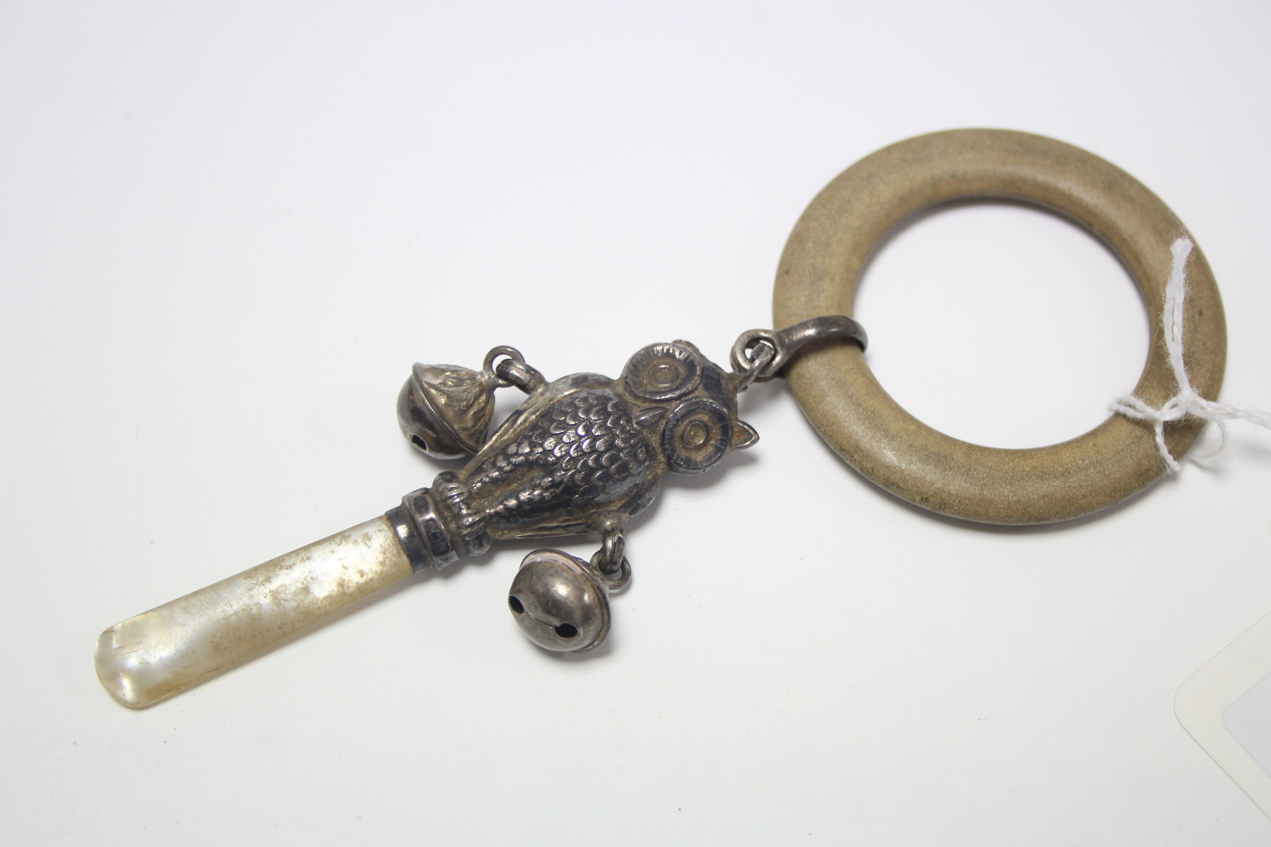 A George V silver baby’s rattle & teether in the form of an owl, Birmingham 1933; & a George VI