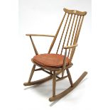 An Ercol light elm spindle-back rocking chair.