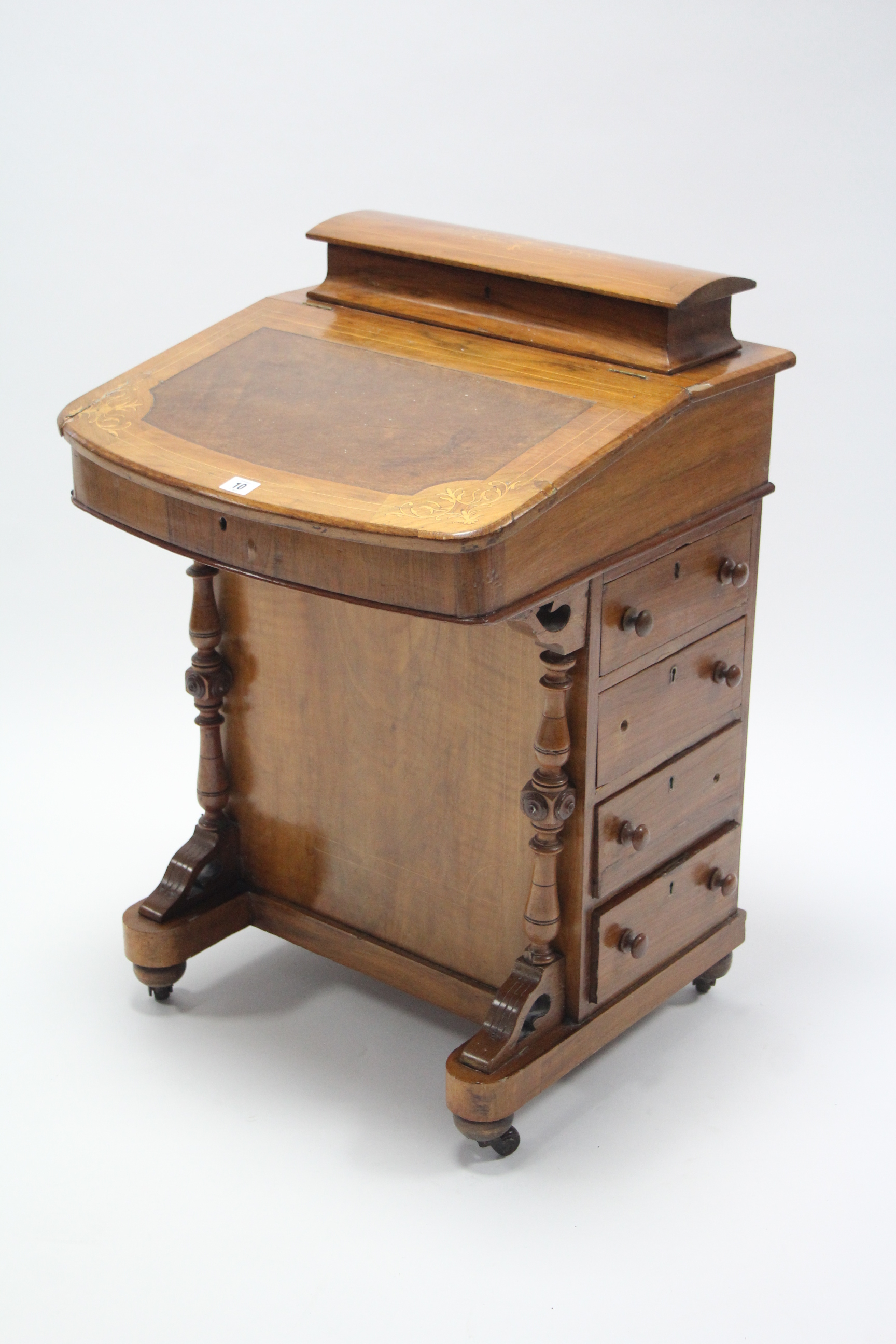 A 19th century inlaid walnut Davenport with hinged compartment to top, enclosed by fall-front,