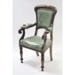 A 19th century oak carver chair with padded back & sprung seat, with scroll arms, & on baluster
