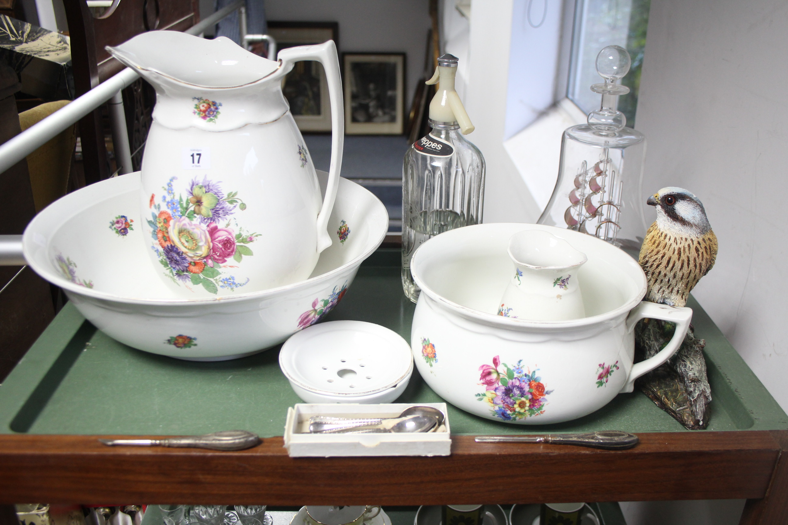 A Pountney & Co. floral decorated five-piece toilet set; a “Schweppes” glass soda syphon bottle;