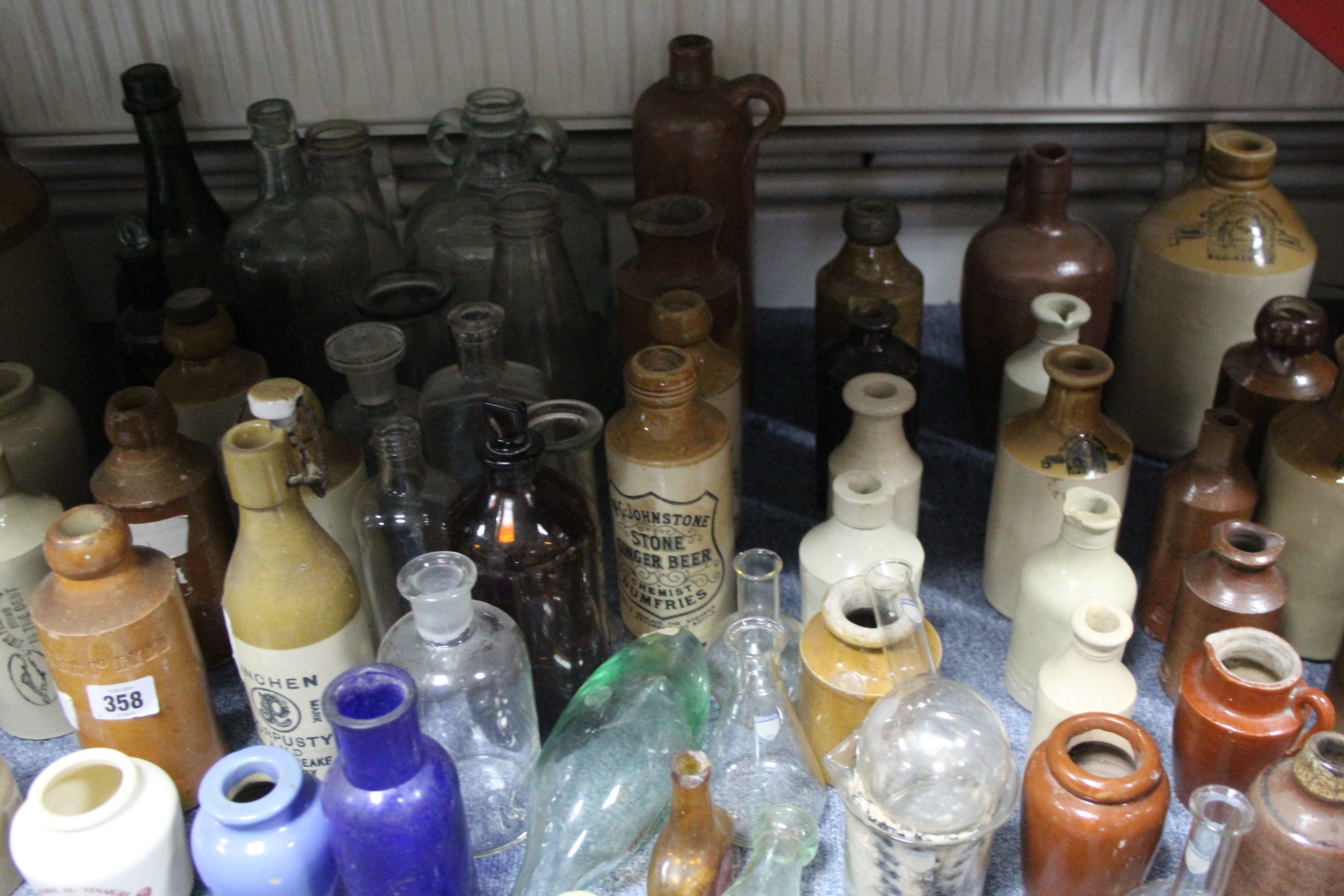 A collection of assorted stoneware bottles & jars, glass bottles, etc.