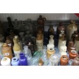 A collection of assorted stoneware bottles & jars, glass bottles, etc.