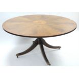 A reproduction inlaid-mahogany large pedestal dining table with circular top, & on turned centre