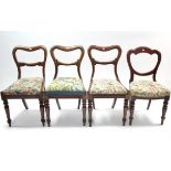 A pair of Victorian mahogany dining chairs with open kidney-shaped backs, padded drop-in seats, & on