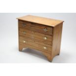 A pine small chest fitted three long graduated drawers with brass swing handles, & on bracket