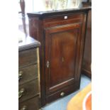 A late 18th century mahogany hanging corner cupboard with inlaid decoration to the panel door,