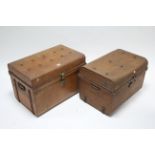Two grained tin travelling trunks, each with hinged lift-lid & wrought-iron side handles, 24” & 25¾”