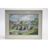 A watercolour painting by G Johns of a village scene with river & bridge to the fore, signed, 14¼” x