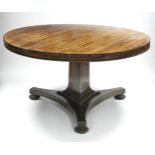 A GEORGE IV ROSEWOOD CENTRE TABLE, the circular top with beaded lower rim, on triform centre column&