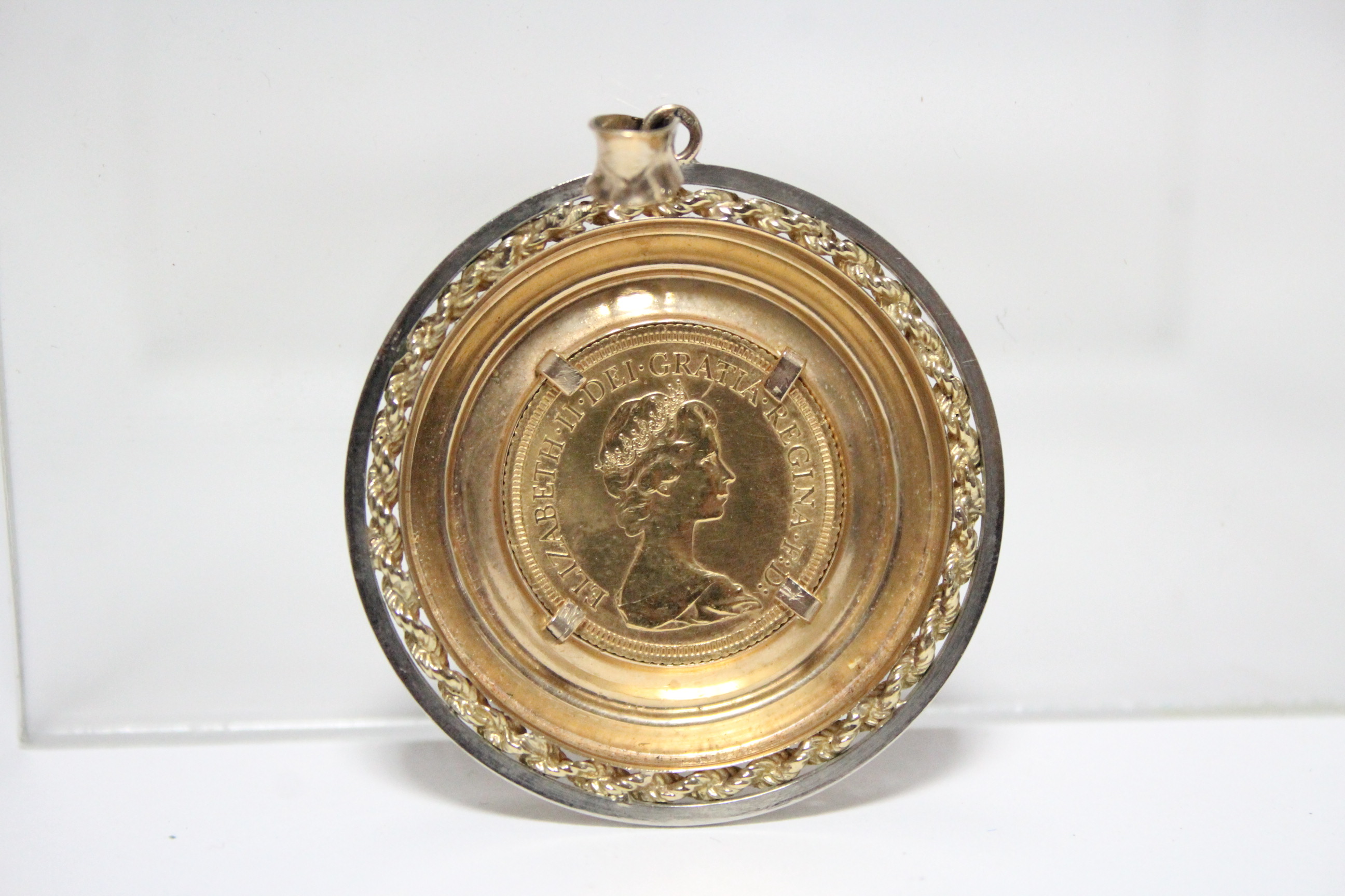 A 1976 Sovereign, loose-mounted as a pendant within a 9ct. yellow & white gold border. - Image 2 of 2