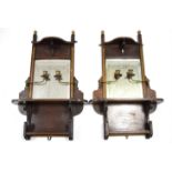 A pair of late Victorian walnut & parcel-gilt wall mirrors, each bevelled plate with brass candle-
