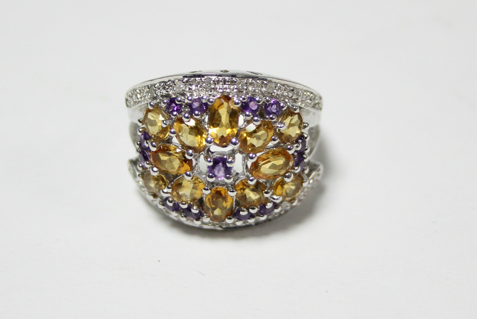 A 14K white gold ring with large cluster panel set small citrines, pink topaz, & diamonds.