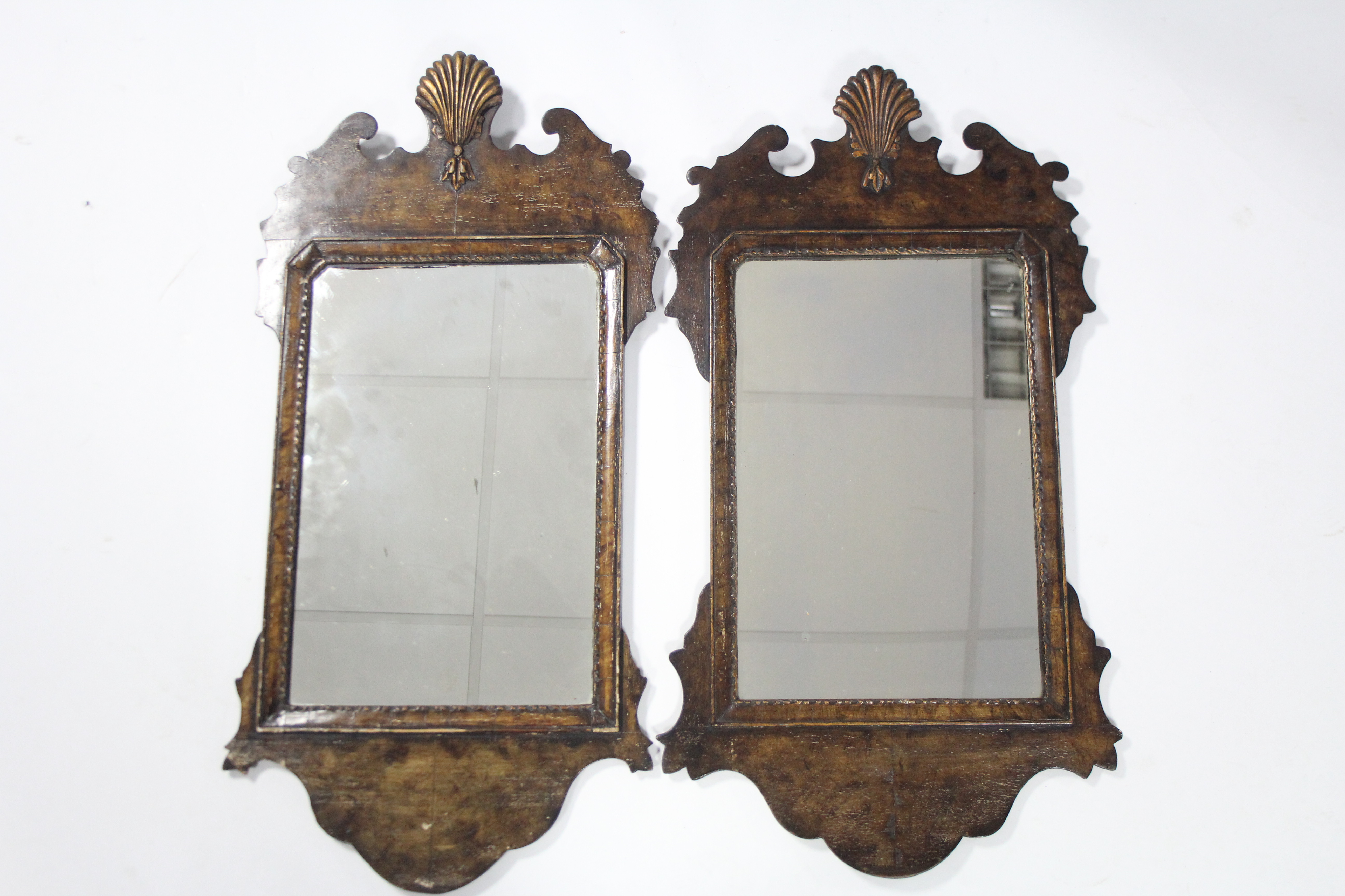 A pair of George III-style mahogany fret-carved rectangular wall mirrors with scallop-shell