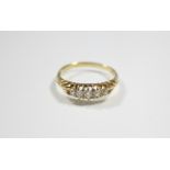 An 18ct. gold ring set row of five small graduated diamonds.