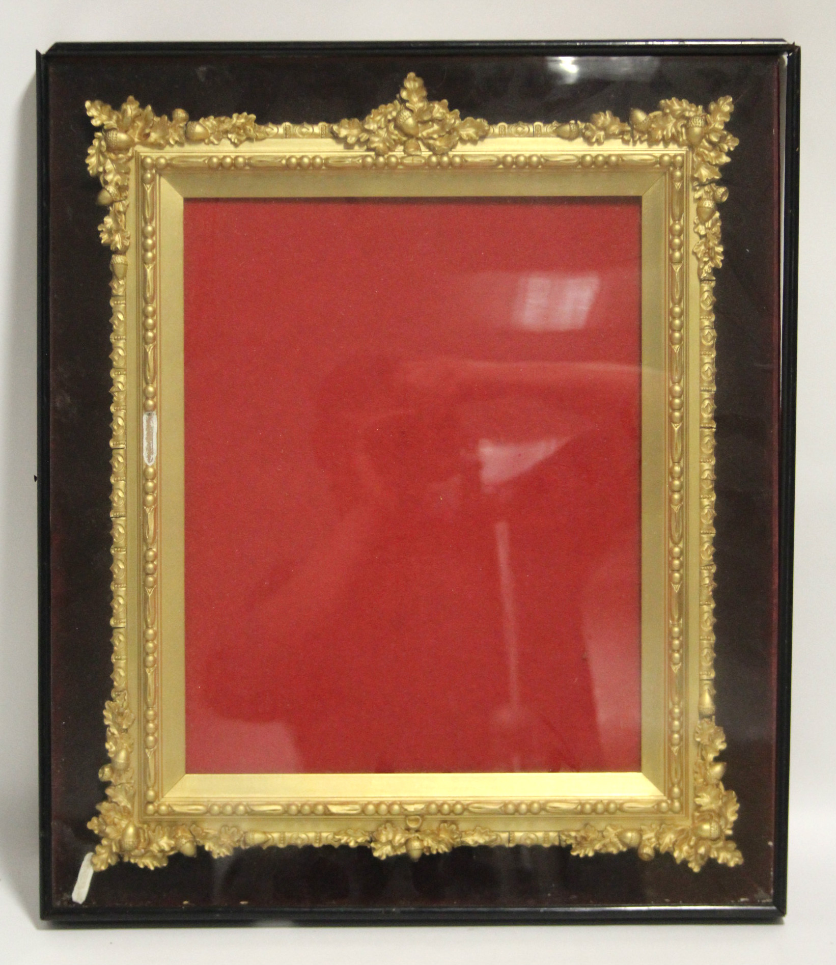 A Victorian gilt-gesso rectangular picture frame in dust-proof glazed case; 22¼” x 19”. (Slight