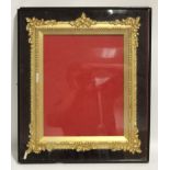 A Victorian gilt-gesso rectangular picture frame in dust-proof glazed case; 22¼” x 19”. (Slight